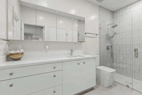 a bathroom with a sink a toilet and shower