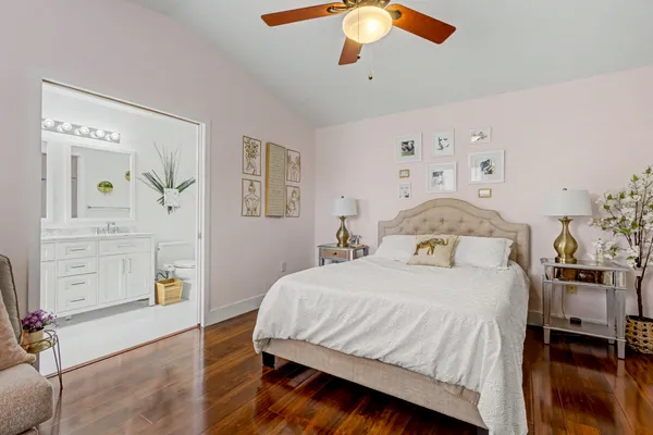a bedroom with a bed and wooden floor