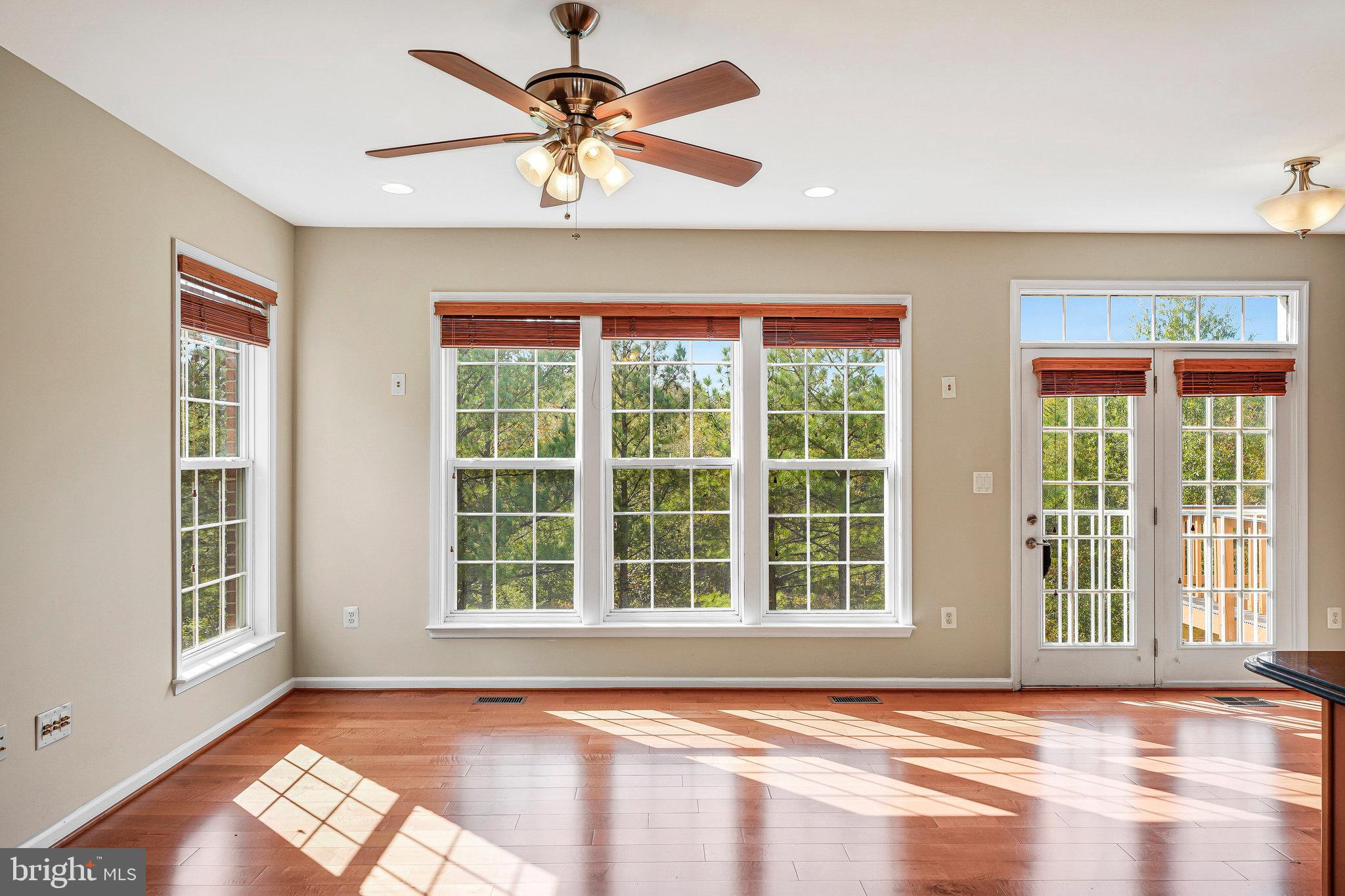 2478 Silk Court Herndon, VA 20171 - Photo 12 of 32 a view of an empty room with a window and wooden floor