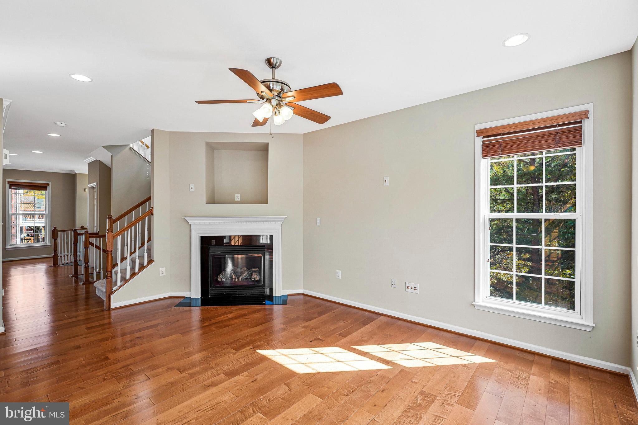 2478 Silk Court Herndon, VA 20171 - Photo 13 of 32 a living room with a fireplace and a window