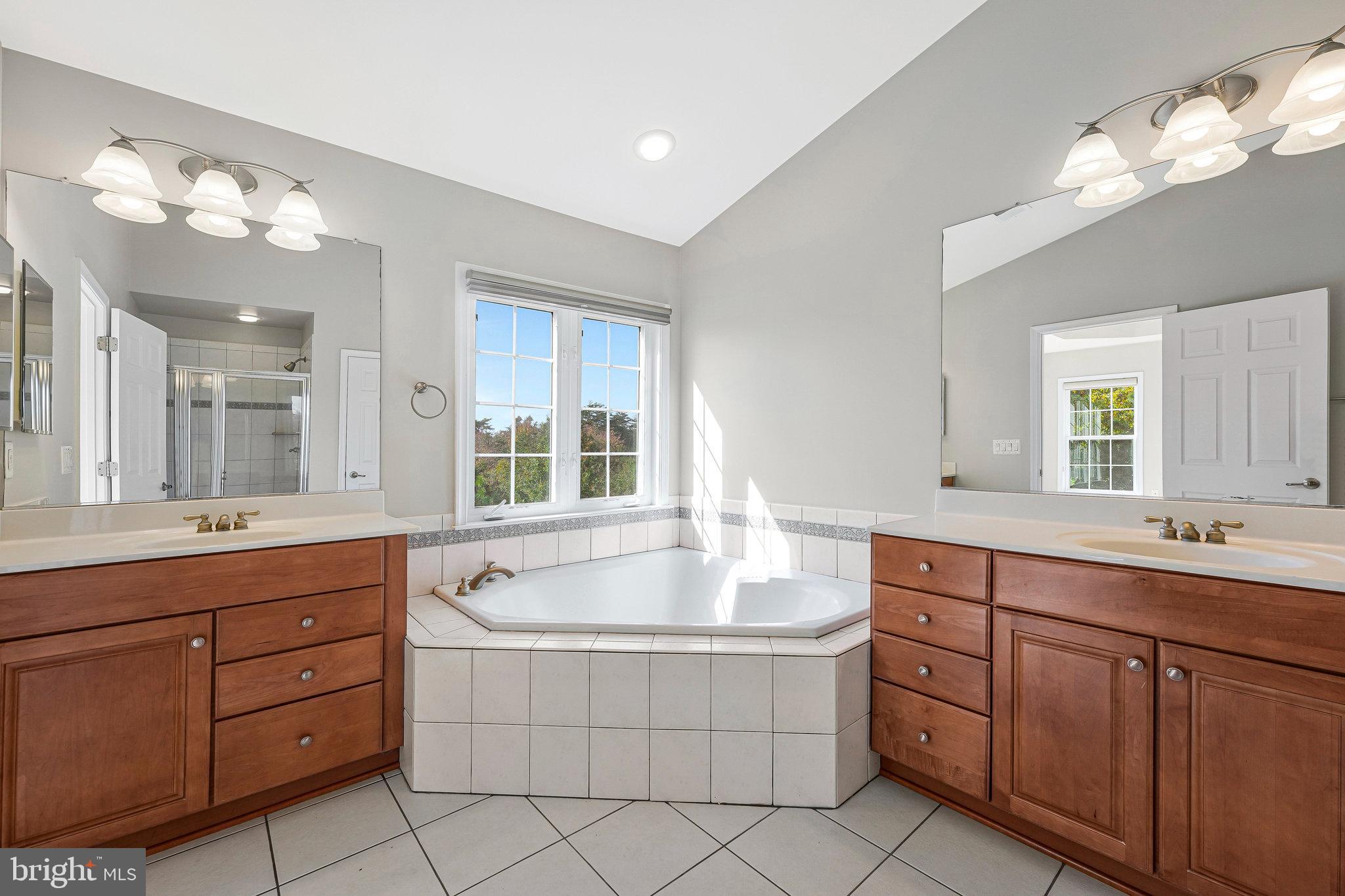 2478 Silk Court Herndon, VA 20171 - Photo 18 of 32 a spacious bathroom with a granite countertop double vanity sink mirror and bathtub
