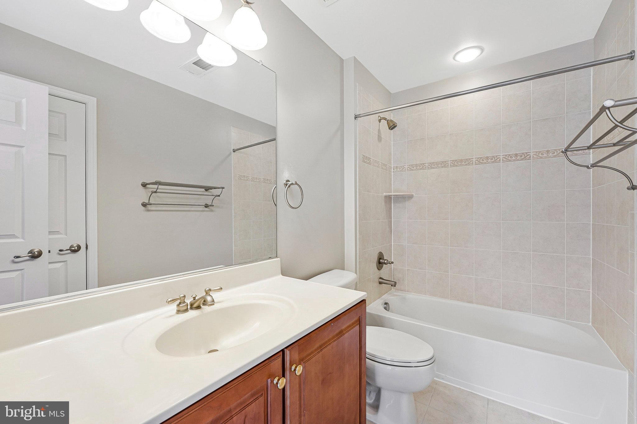 2478 Silk Court Herndon, VA 20171 - Photo 25 of 32 a bathroom with a sink a toilet and shower