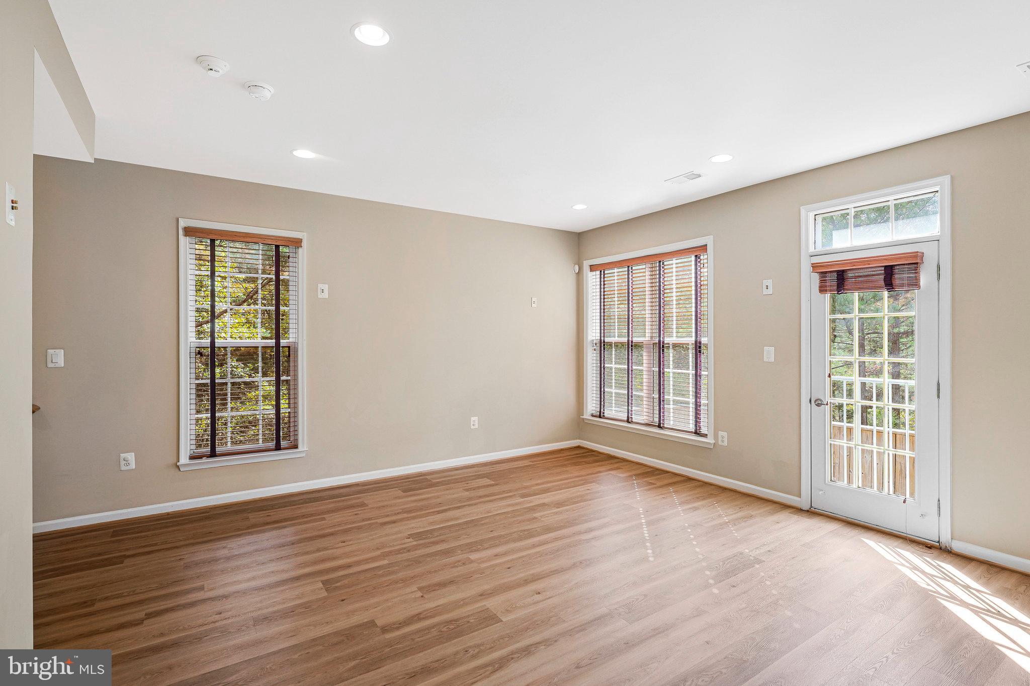 2478 Silk Court Herndon, VA 20171 - Photo 29 of 32 a view of an empty room with wooden floor and a window