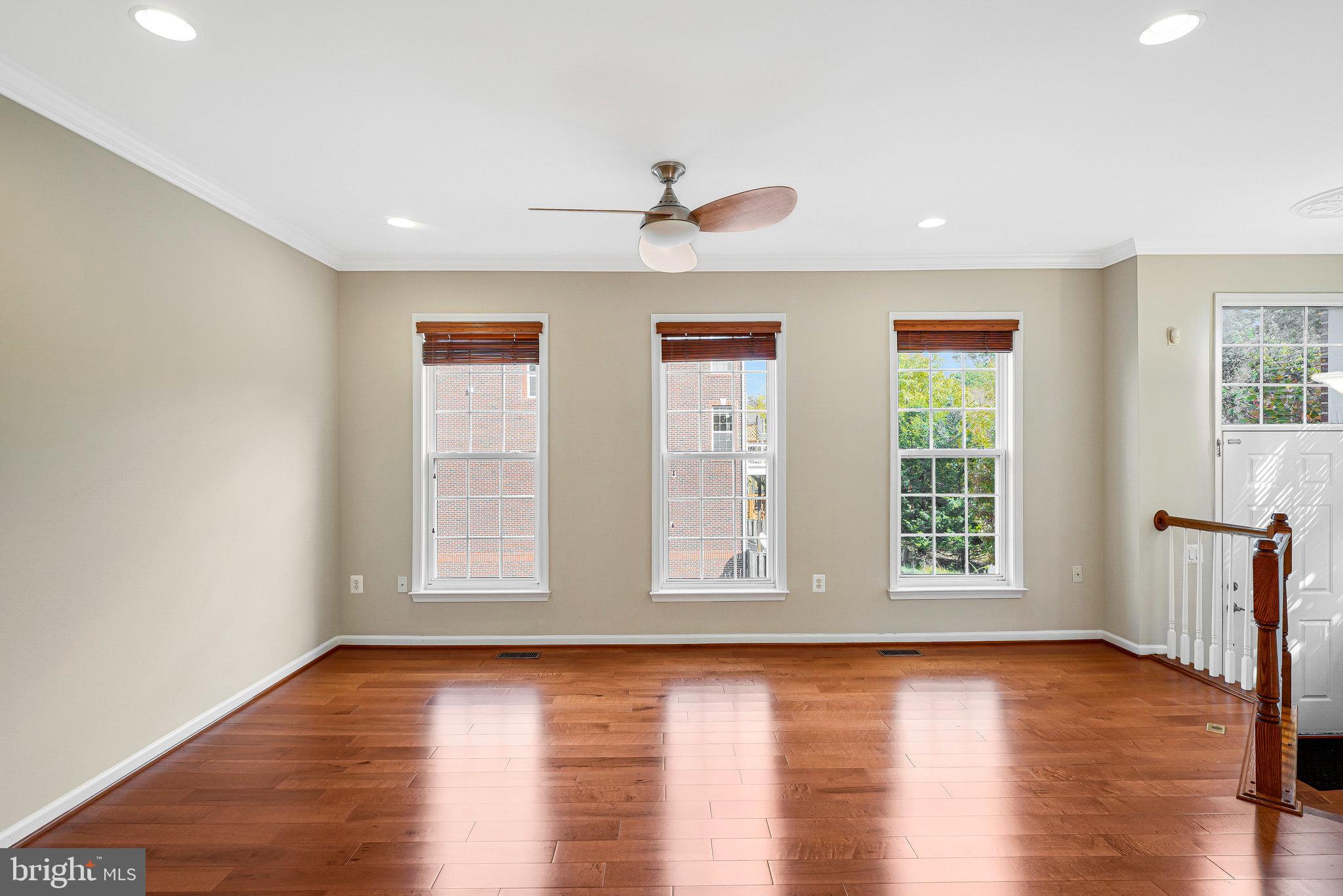 2478 Silk Court Herndon, VA 20171 - Photo 5 of 32 a view of an empty room with wooden floor and a window