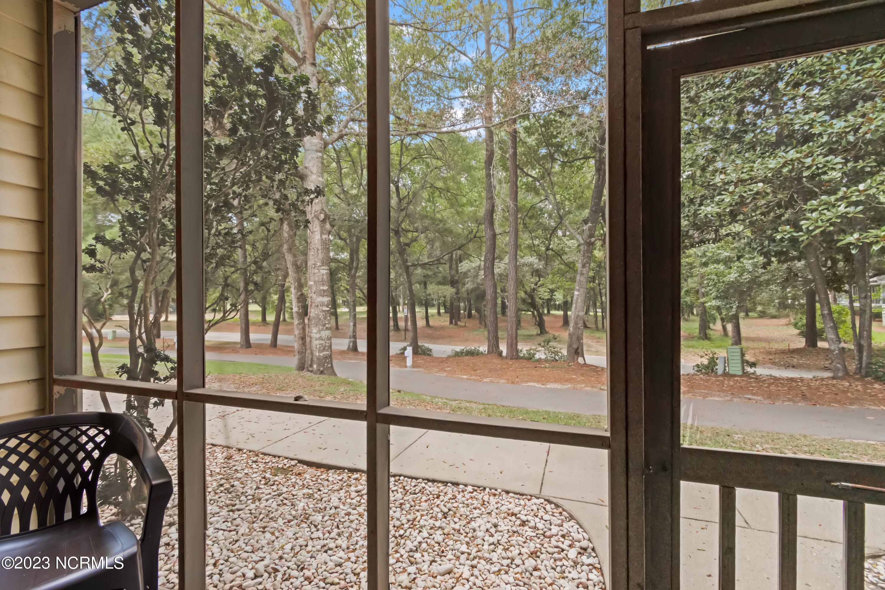 226 Clubhouse Road, Unit 17D Sunset Beach, NC 28468 - Photo 18 of 37 Enjoy a back exit from this screened porch area.