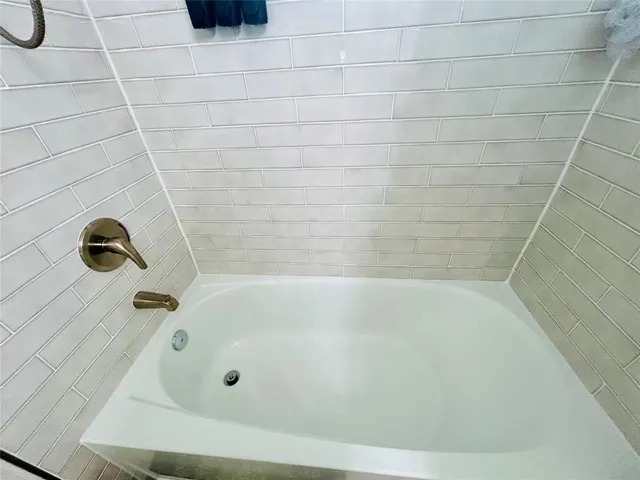 a spacious bedroom with a bed and window