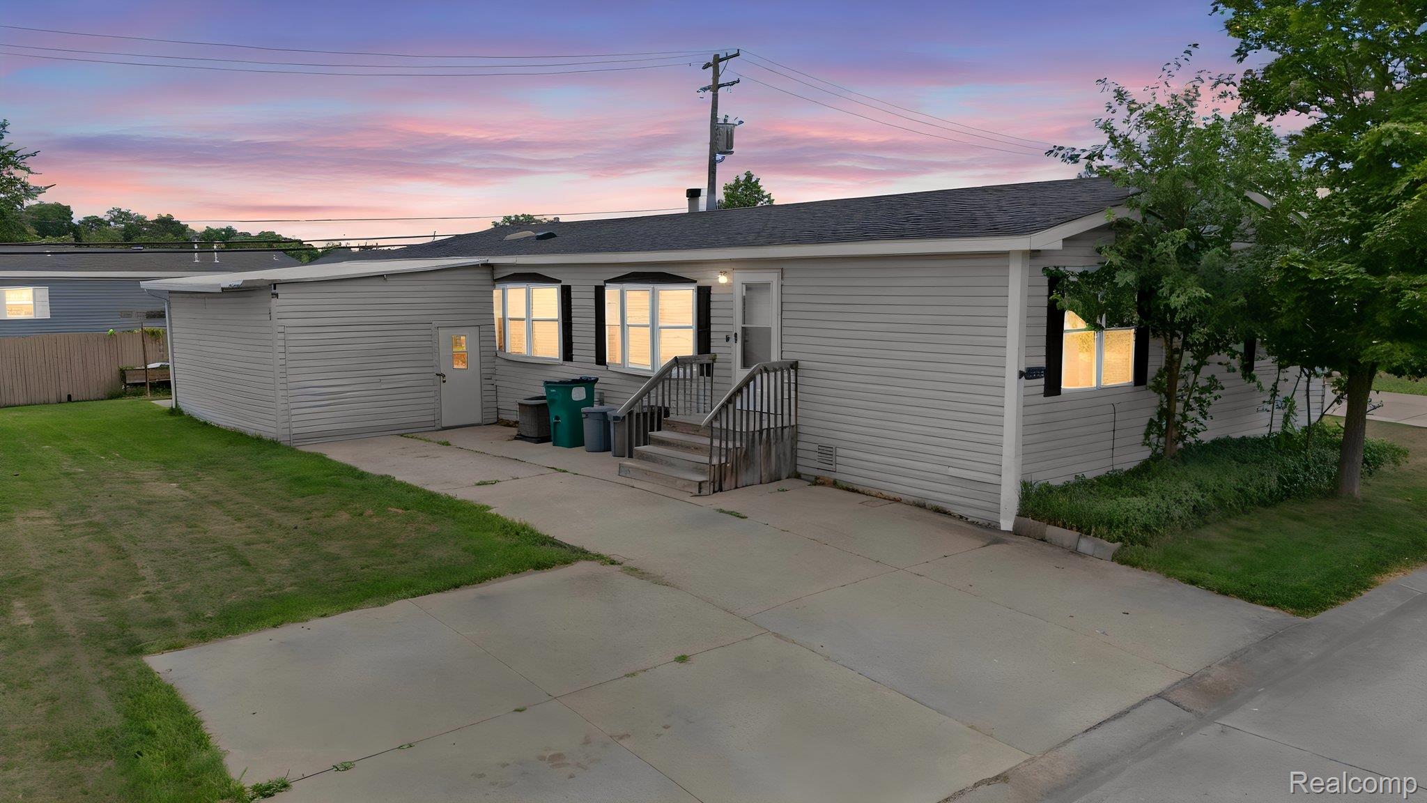 19921 Rhapsody Drive Clinton Township, MI 48036 - Photo 1 of 19 Siding exterior with multiple windows, a concrete driveway, and a detached storage structure