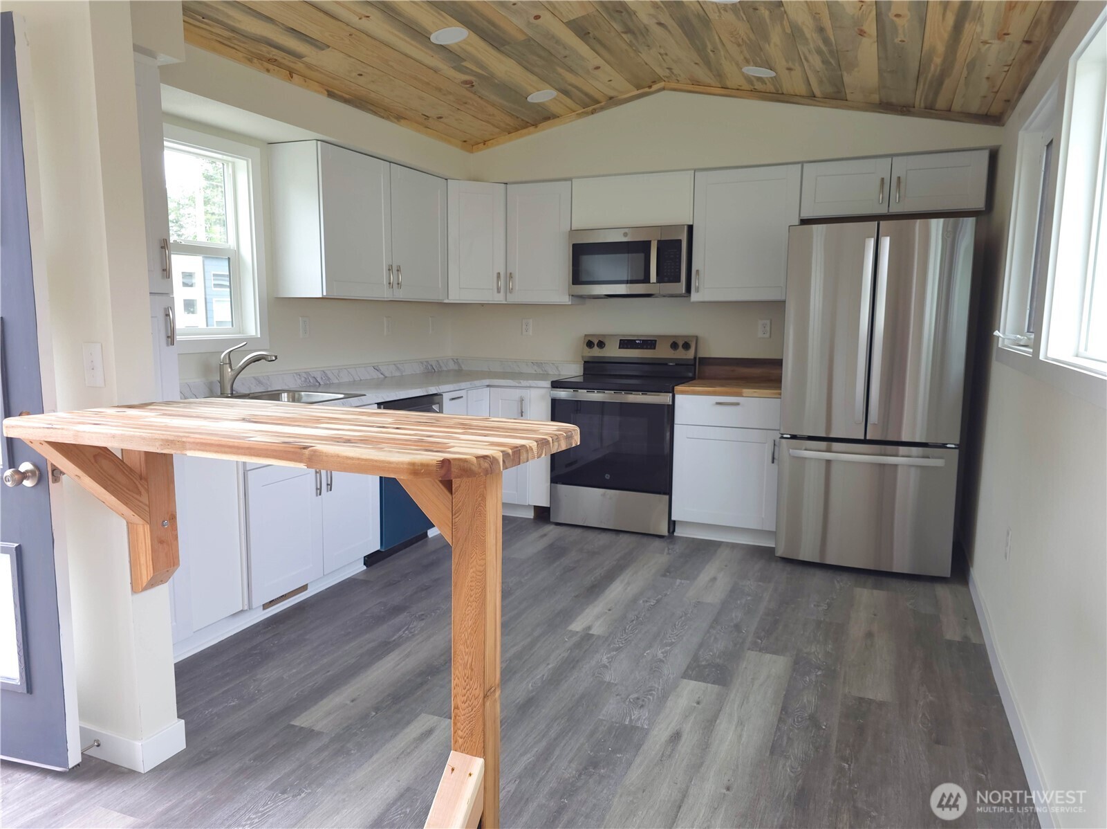 1303 30th Street, Unit 23 Seaview, WA 98644 - Photo 4 of 24 a kitchen with a sink appliances and wooden floor