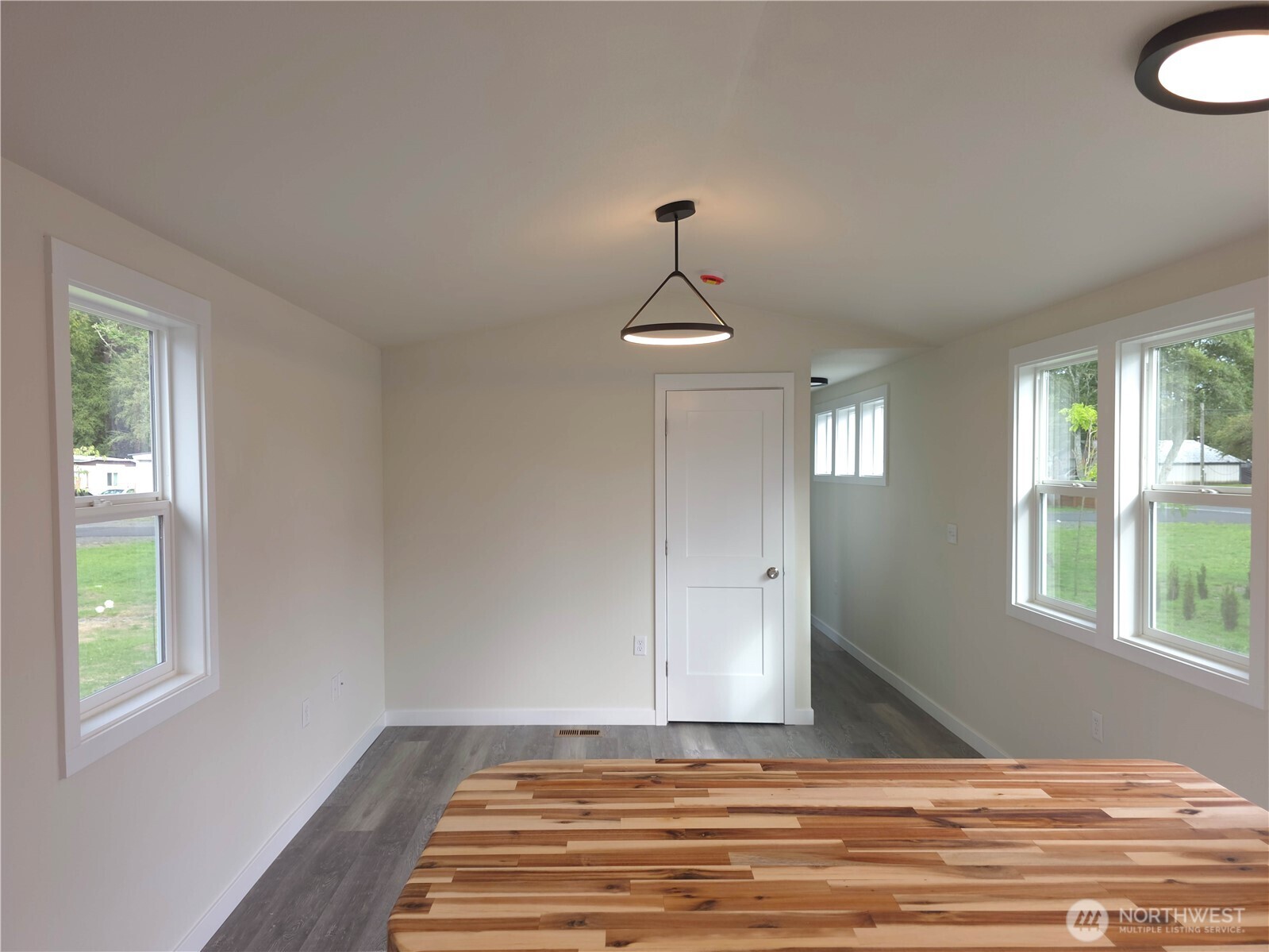 1303 30th Street, Unit 23 Seaview, WA 98644 - Photo 9 of 24 a view of a livingroom with wooden floor and window