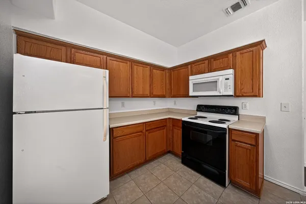 a kitchen with stainless steel appliances granite countertop a refrigerator stove a sink and dishwasher