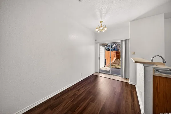 a view of room with window and wooden floor