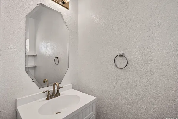 a bathroom with a sink and mirror