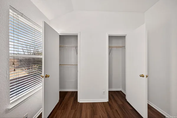 a view of a hallway with wooden floor and closet