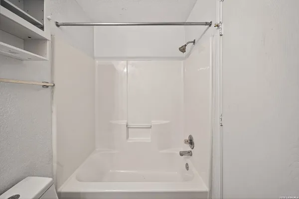 a bathroom with a shower and a toilet