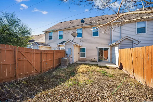 a view of a house with wooden fence