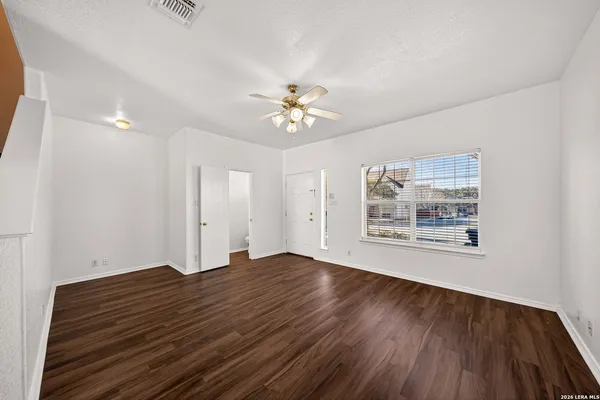 wooden floor in an empty room with a window