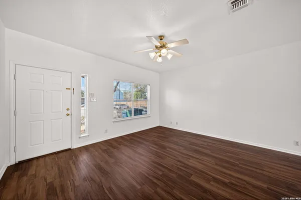 wooden floor in an empty room with a window