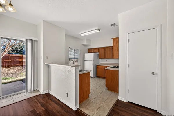 a kitchen with a refrigerator and a stove top oven