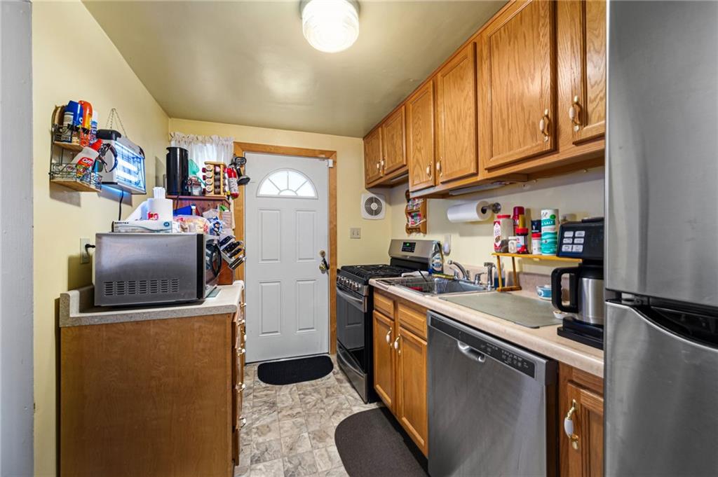 7148 Vann Road Pittsburgh, PA 15206 - Photo 11 of 36 a view of a kitchen with fridge and workspace