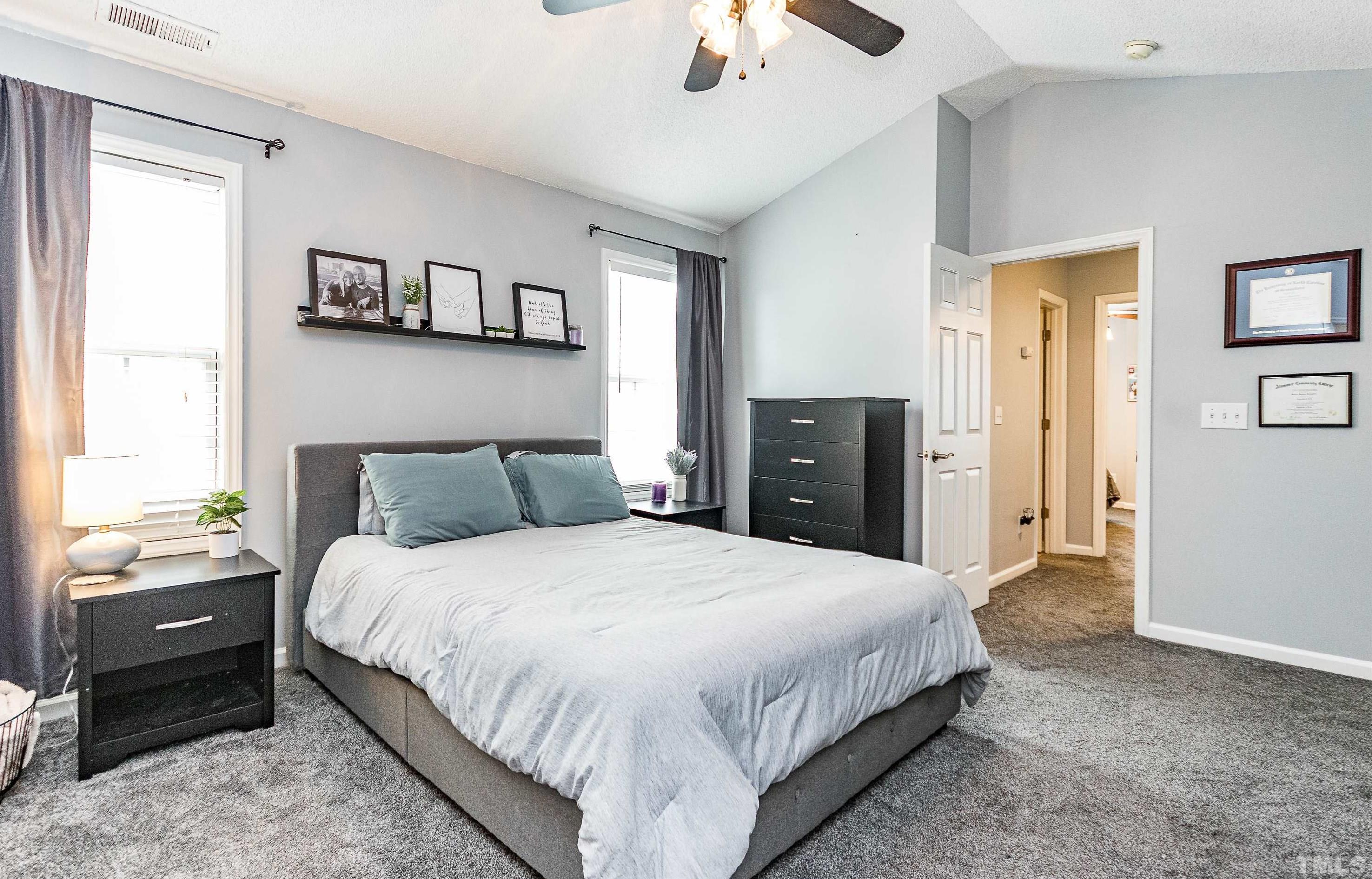 4924 Mocha Lane Raleigh, NC 27616 - Photo 11 of 16 a bedroom with a bed and a chandelier