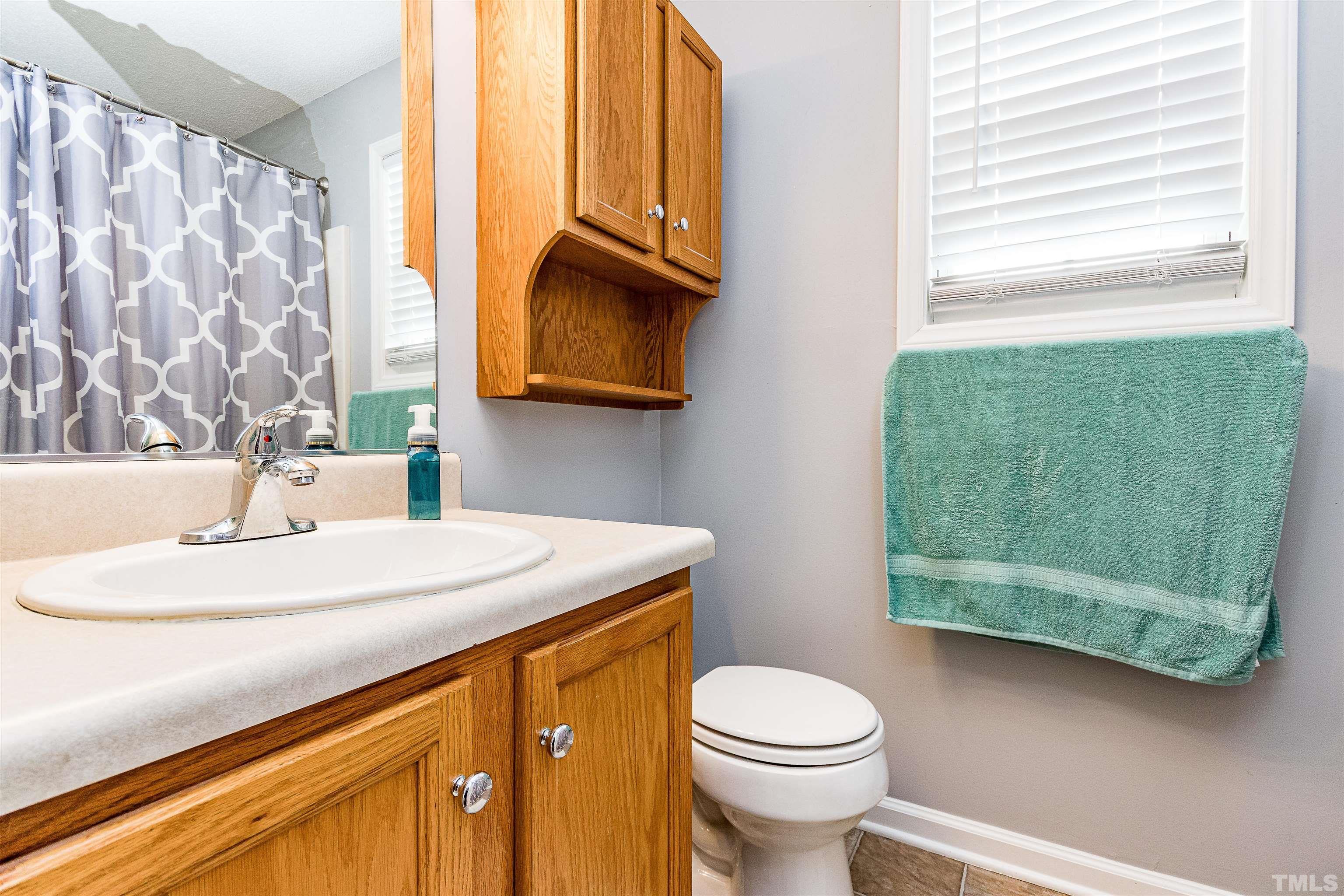 4924 Mocha Lane Raleigh, NC 27616 - Photo 14 of 16 a bathroom with a sink a toilet and shower