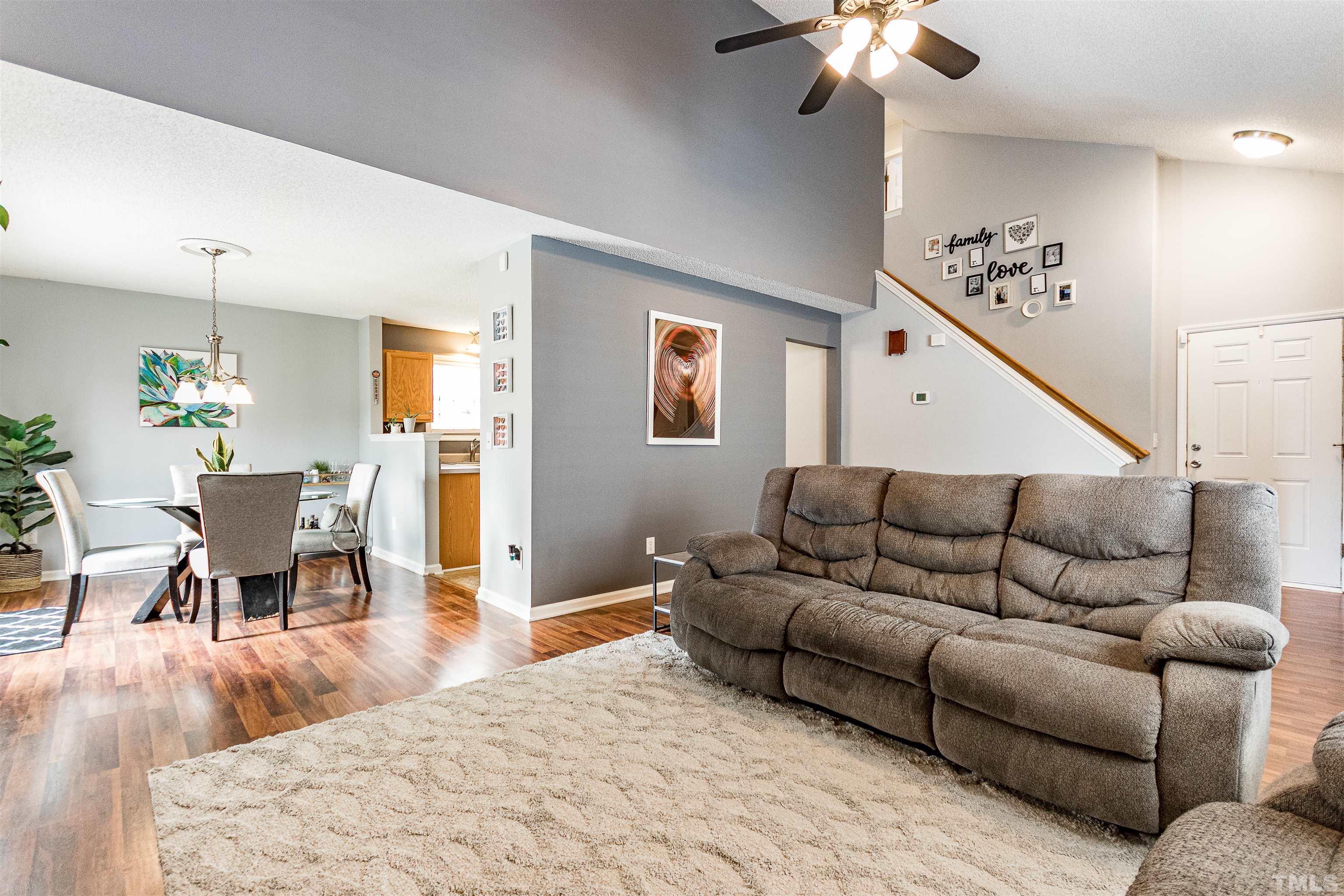 4924 Mocha Lane Raleigh, NC 27616 - Photo 4 of 16 a living room with furniture and a chandelier