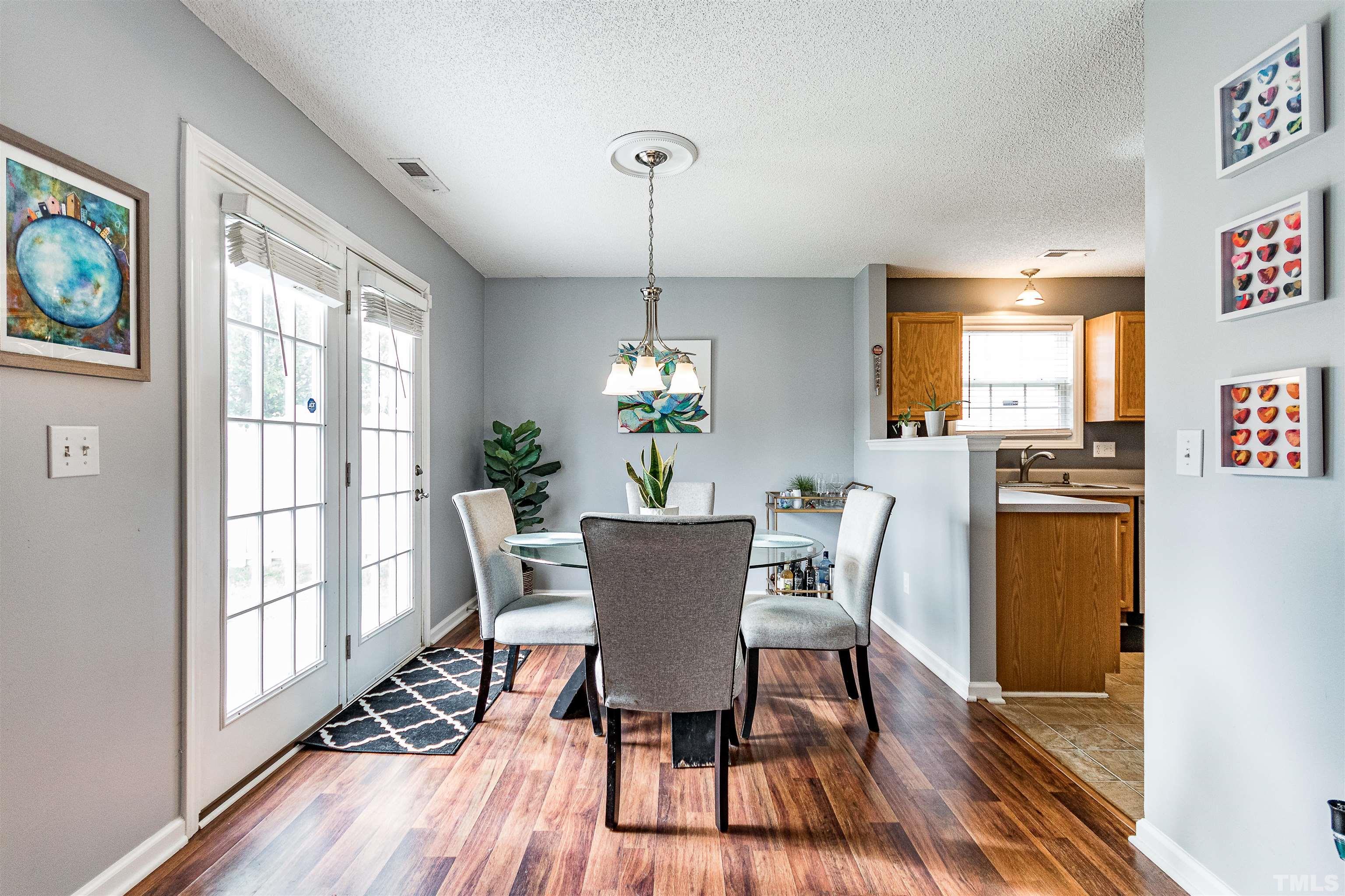 4924 Mocha Lane Raleigh, NC 27616 - Photo 5 of 16 a dining room with furniture window wooden floor