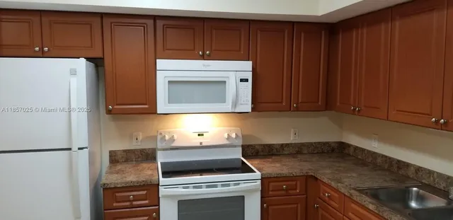 a kitchen with appliances and cabinets