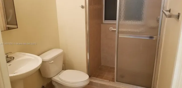 a white toilet sitting next to a bathroom sink