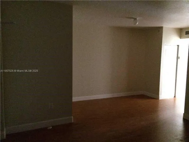 an empty room with wooden floor