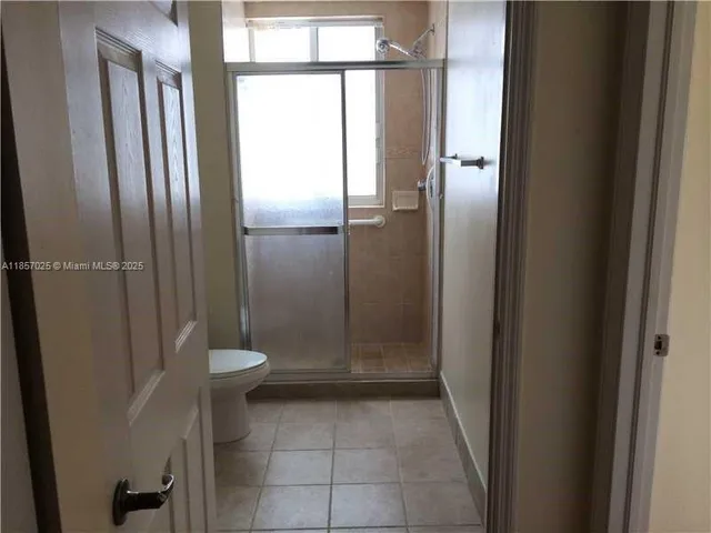 a bathroom with a glass shower door