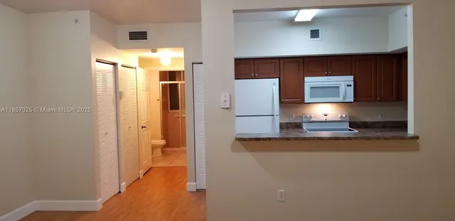 a view of a kitchen from the hallway