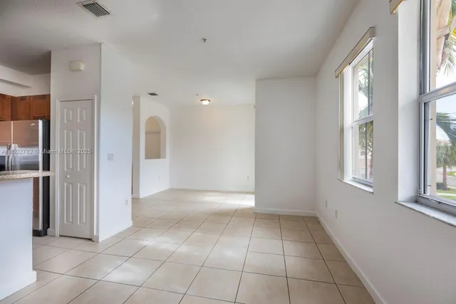 a kitchen with granite countertop a sink stove and microwave
