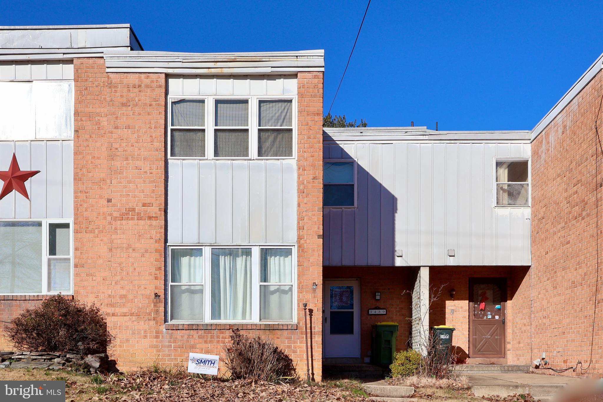a front view of a building with a garden