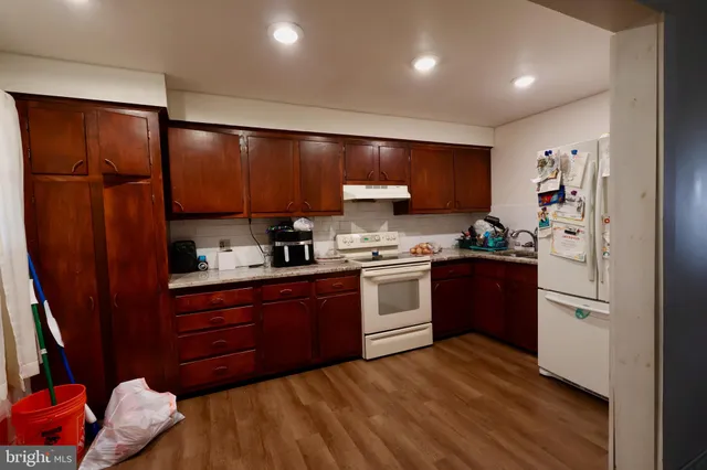a kitchen with stainless steel appliances granite countertop a refrigerator sink and cabinets