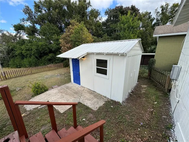 a view of a backyard with a small cabin