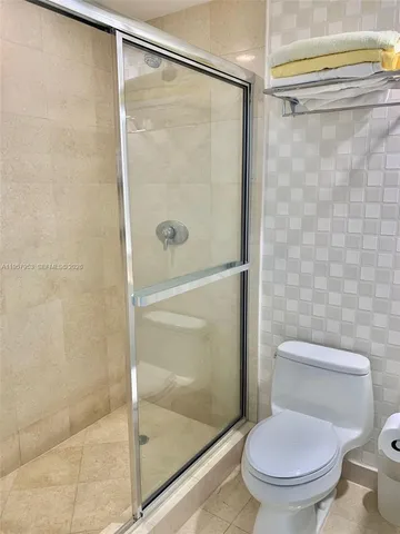 a room with lots of potted plants and wooden floor