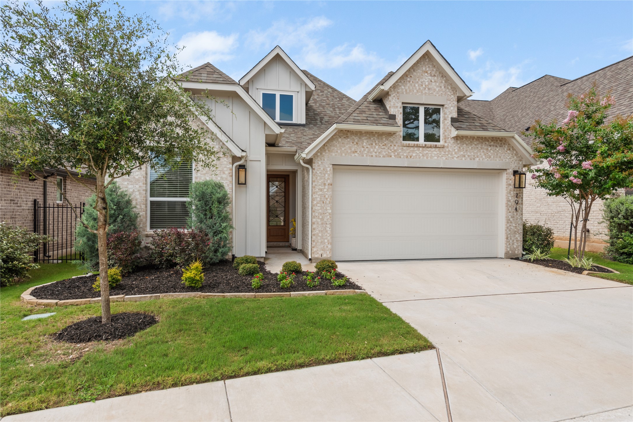 294 Kimble Creek Loop Kyle, TX 78640 - Photo 26 of 40 A well-maintained facade with brick and board-and-batten accents creates inviting curb appeal.