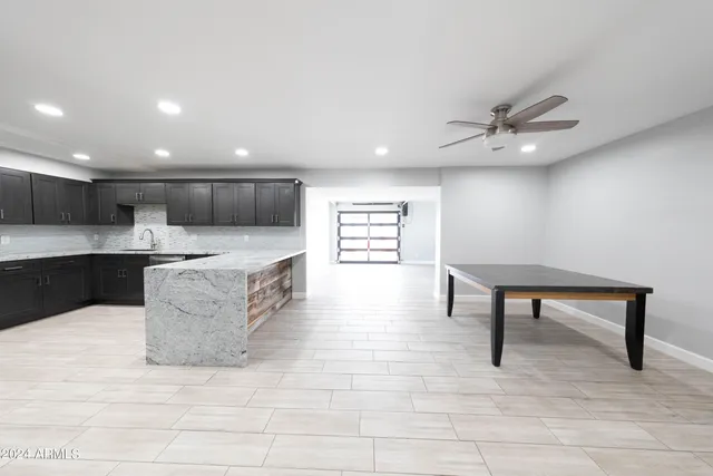 a view of kitchen with stainless steel appliances kitchen island wooden floor and window
