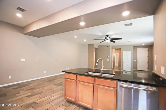 a view of a livingroom with a ceiling fan and window