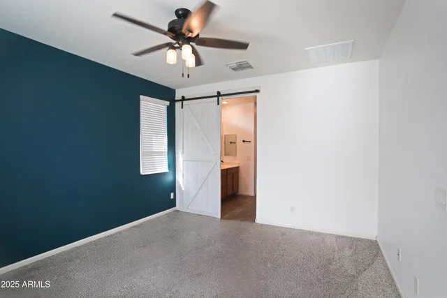 a view of a livingroom with a ceiling fan and window