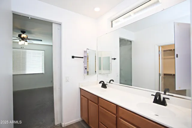 a en suite bathroom with a double vanity sink and mirror