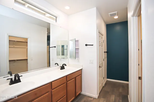 a bathroom with a glass shower door and a shower