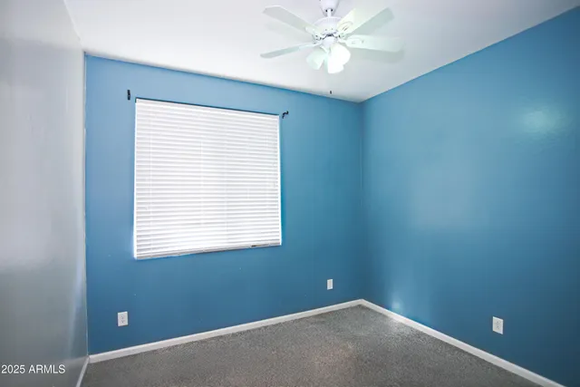an empty room with a ceiling fan