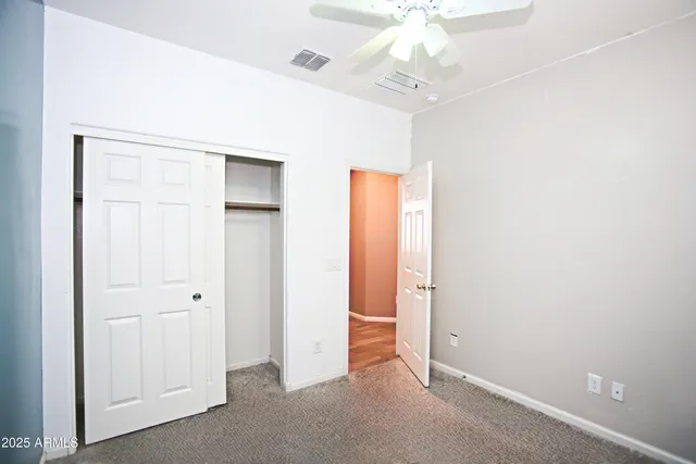 an empty room with ceiling fan