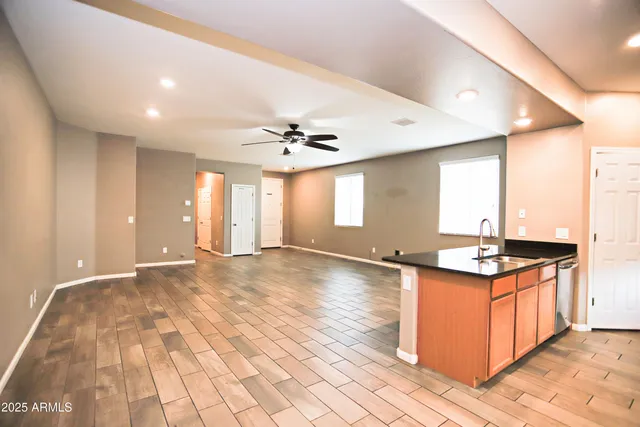 a large kitchen with stainless steel appliances granite countertop a stove and cabinets