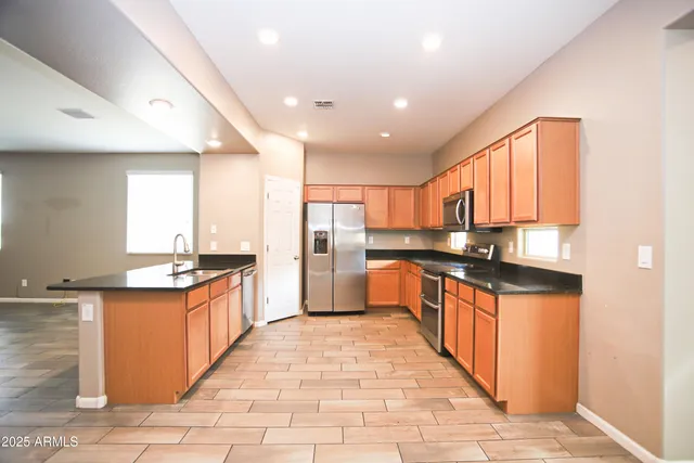 a kitchen with stainless steel appliances granite countertop a stove and a sink