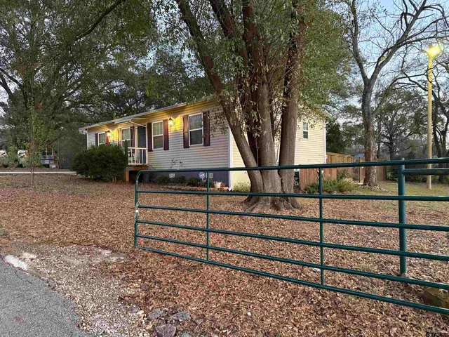 a view of a house with wooden fence