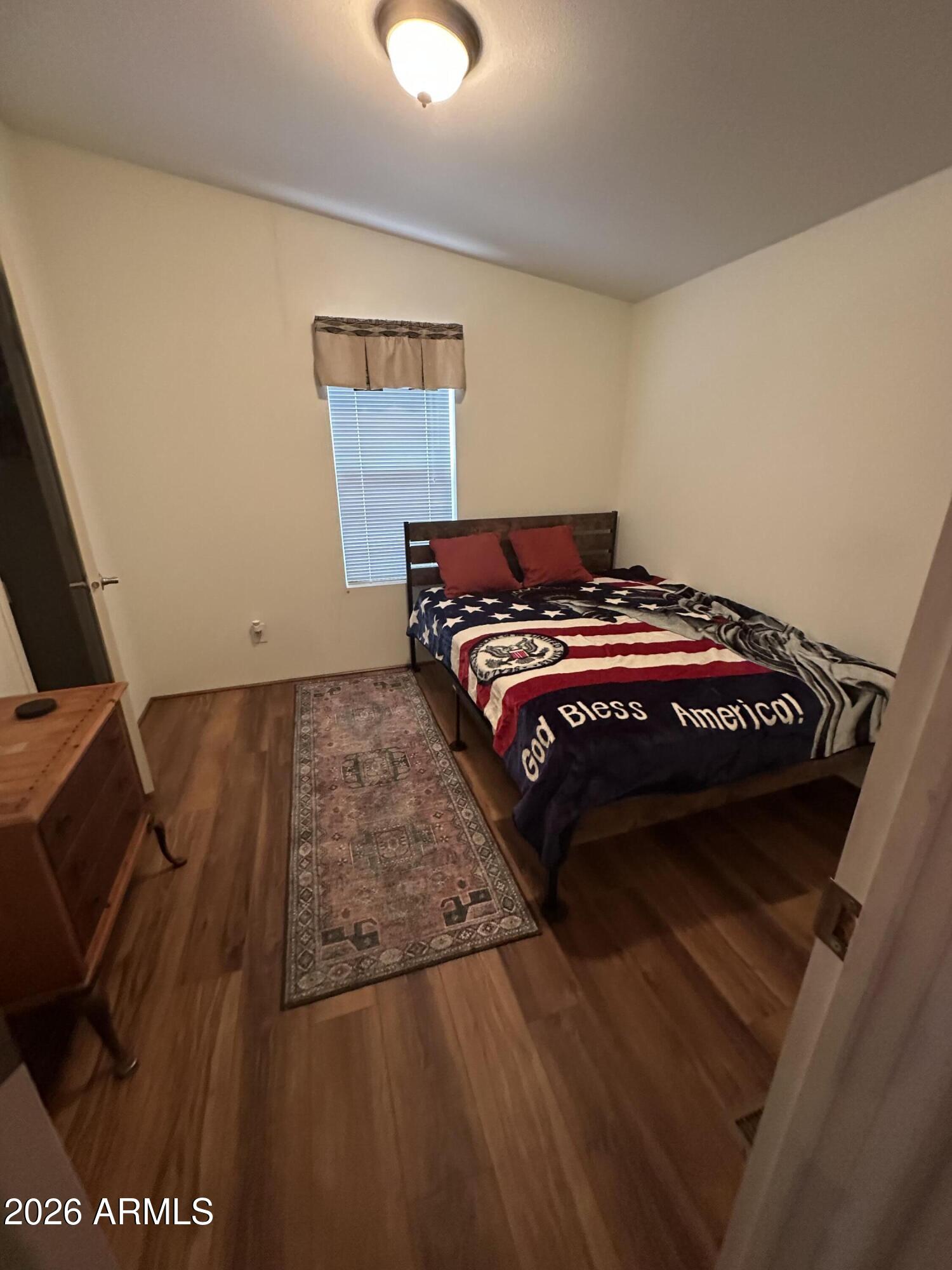 17200 West Bell Road, Unit 1658 Surprise, AZ 85374 - Photo 12 of 16 a bedroom with a bed and a night stand