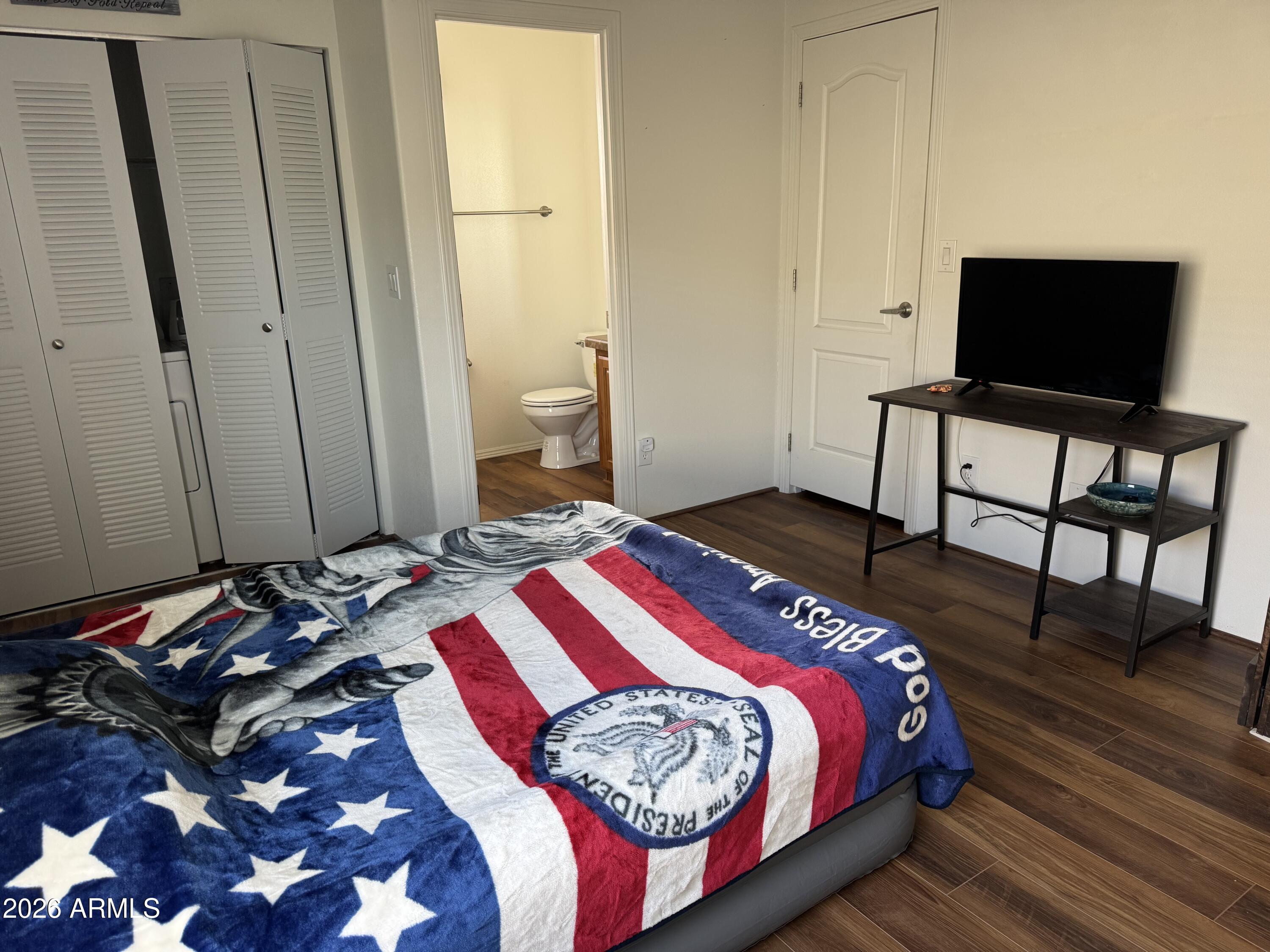 17200 West Bell Road, Unit 1658 Surprise, AZ 85374 - Photo 14 of 16 a bedroom with a bed and a flat screen tv